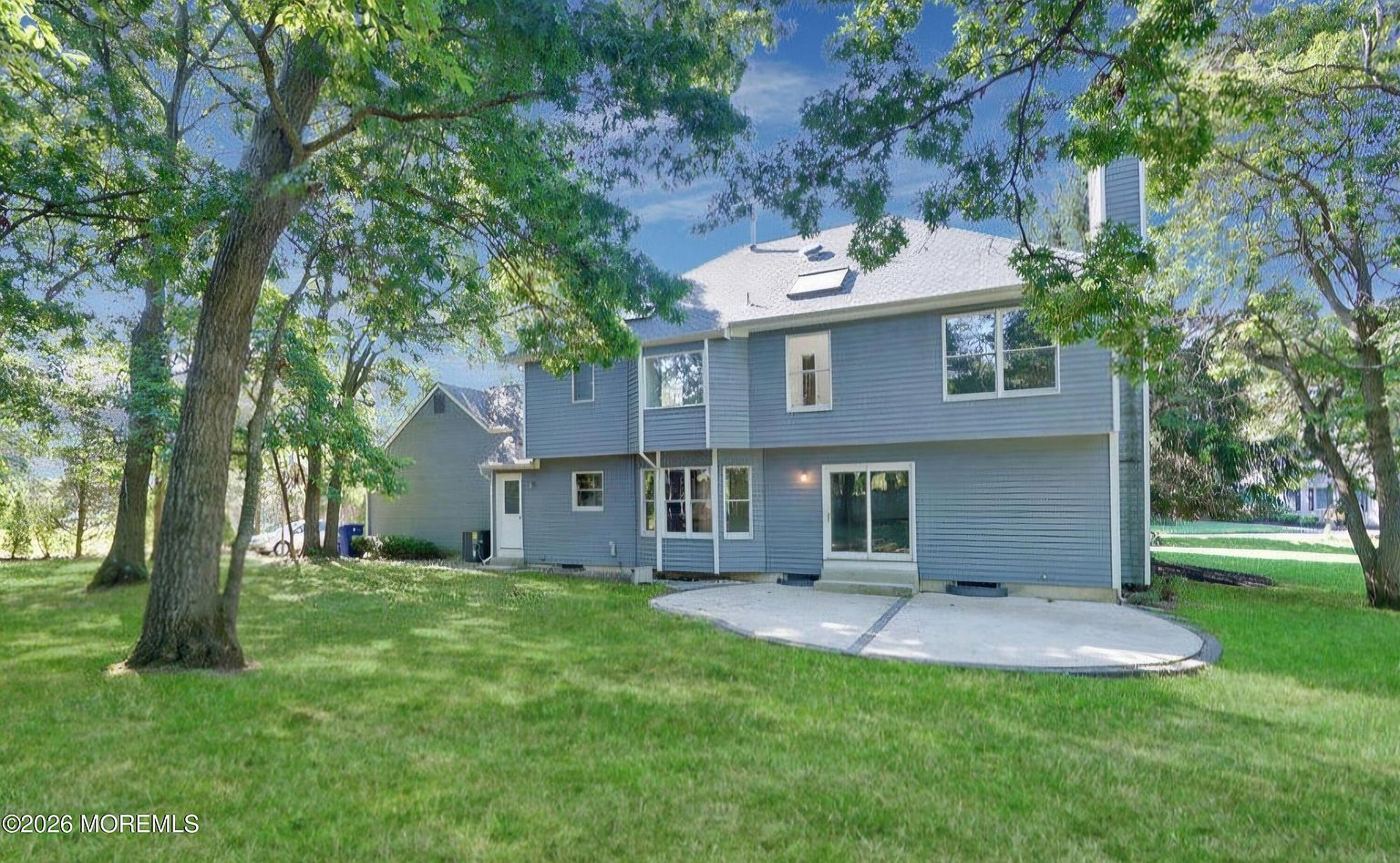 Back of the house with patio and lawn