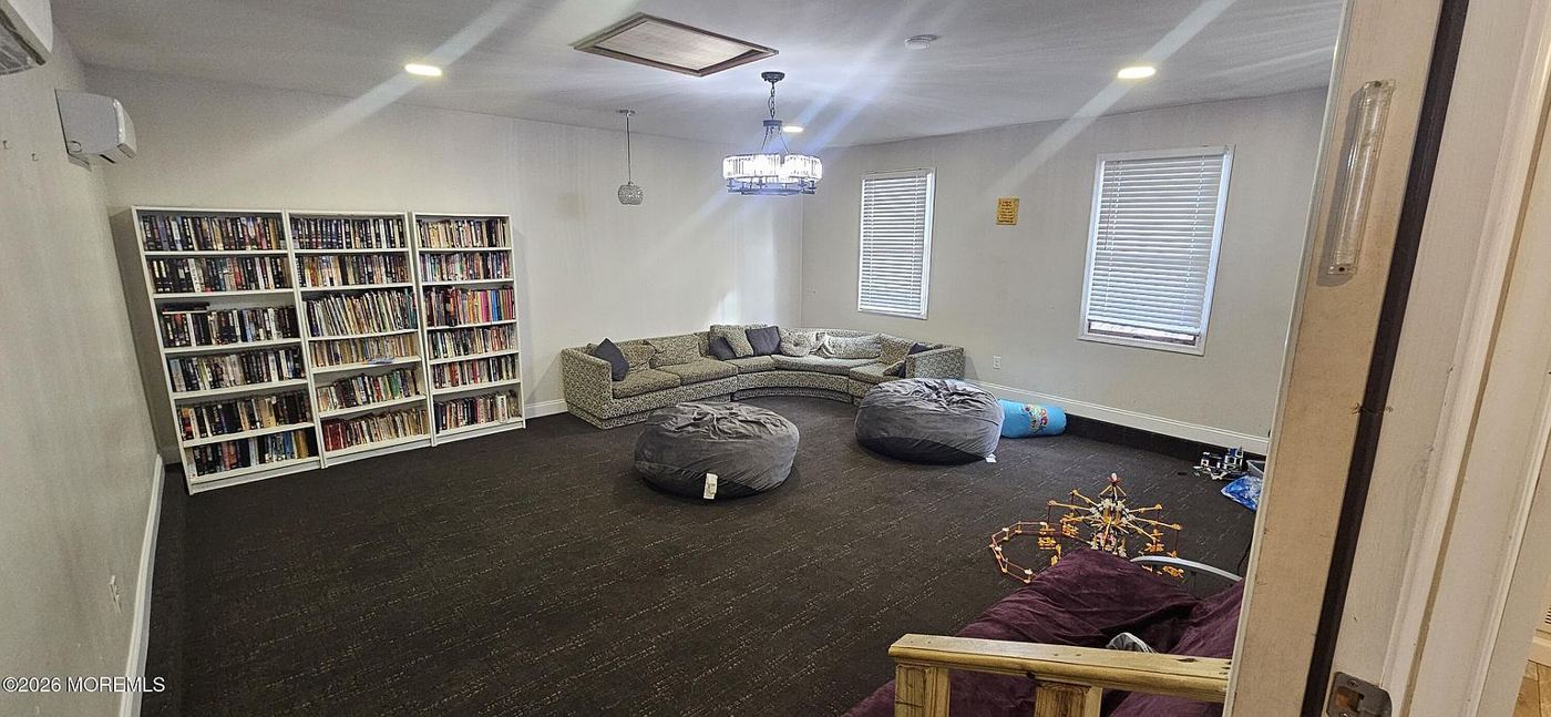 Large carpeted playroom with couches and bean bags